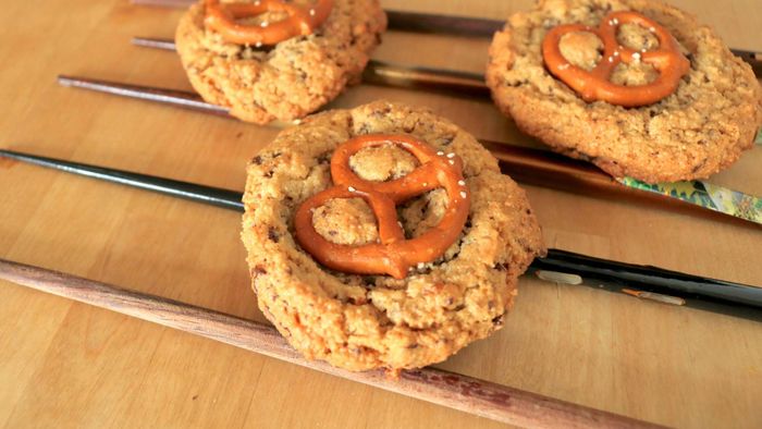 Three cookies sit atop neatly arranged chopsticks.