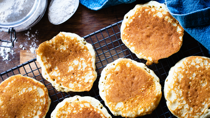 Pancakes resting on a cooling rack.