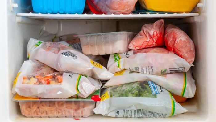 A freezer stocked with frozen vegetables, meats, and various food items