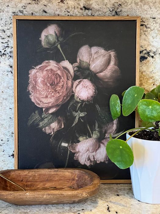 A floral painting on a reviewer's countertop
