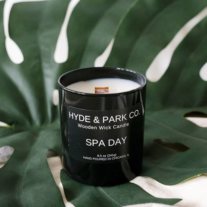 A Spa Day scented candle with a crackling wooden wick, perfect for setting a serene ambiance.