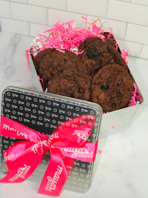 A decorative tin filled with rich, chocolatey cookies, perfect for gifting or indulging.