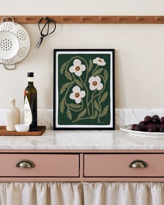 A floral print placed on a kitchen countertop.