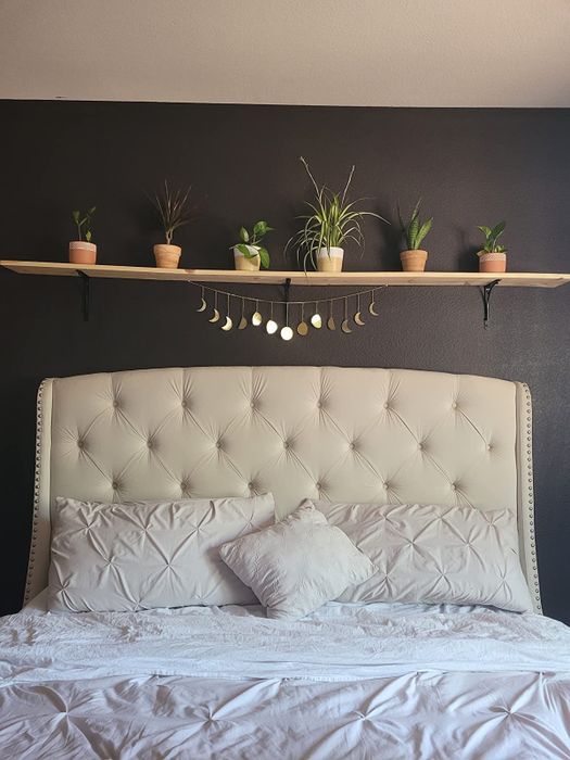 A moon phase garland hanging above a reviewer's bed.