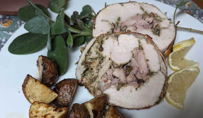 Image of turkey porchetta adorned with lemon pinwheel