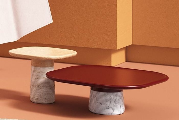 Two tables featuring marble bases paired with sleek, wooden tops, combining elegance and modern style.