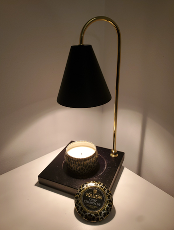 Another review photo featuring a lamp on an empty bedside table.