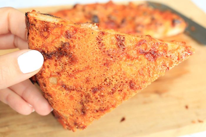 After baking, the parmesan cheese layer has cooked through, turning brown and crisp at the bottom of each slice.