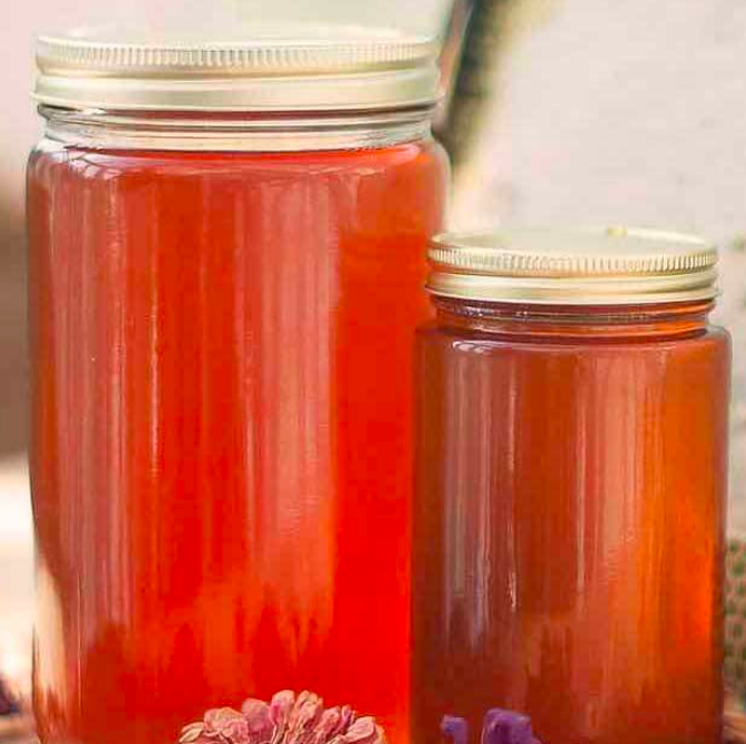 Two jars filled with pure, fresh honey.
