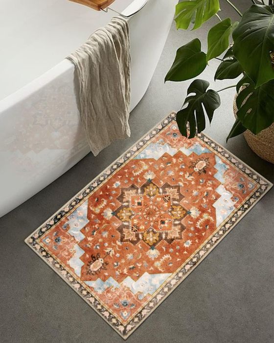 A bath mat with a vintage-inspired rust color that gives off an antique charm.