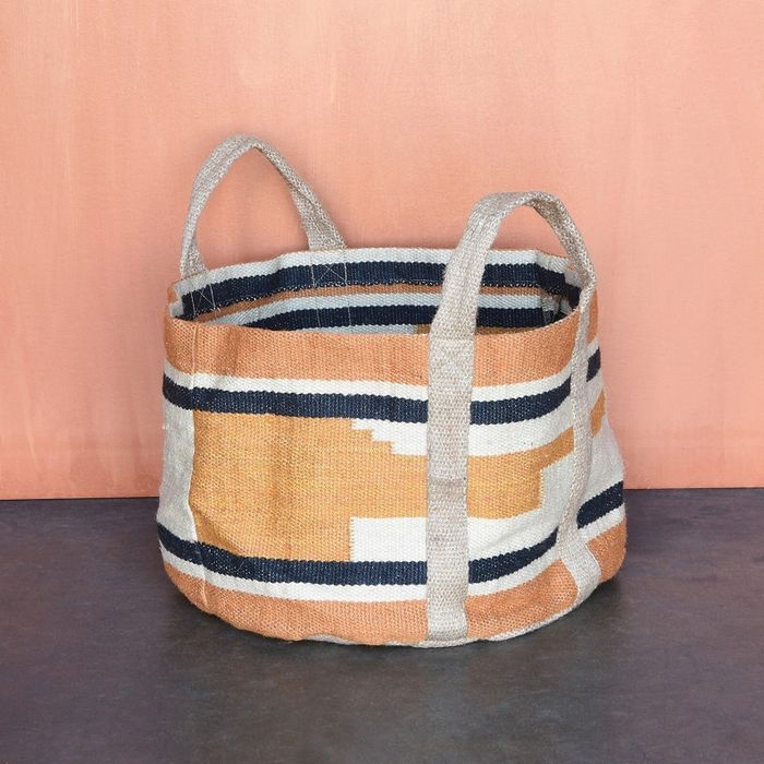 A woven basket designed for storage on the floor.