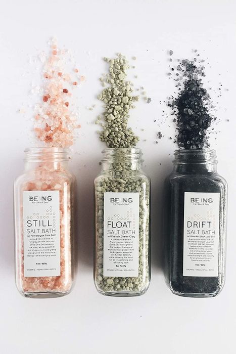 A set of three different bath salts, each contained in a glass jar.