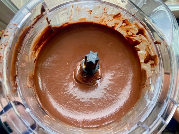 A food processor containing the completed chocolate pie filling.