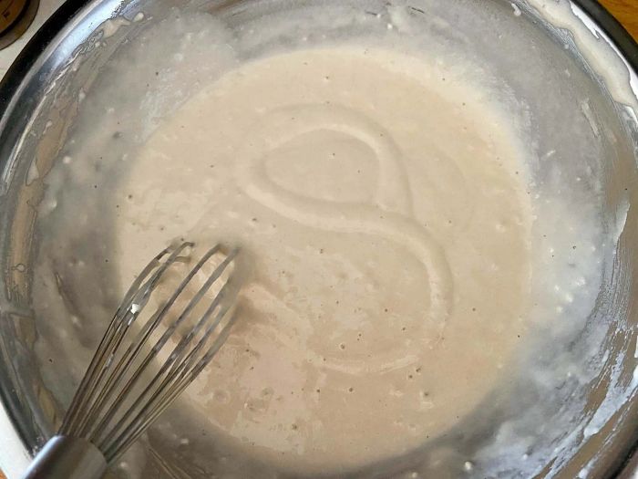 A bowl of pancake batter after being thoroughly whisked.