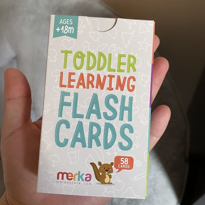 A photo of the reviewer holding the pack of flash cards.