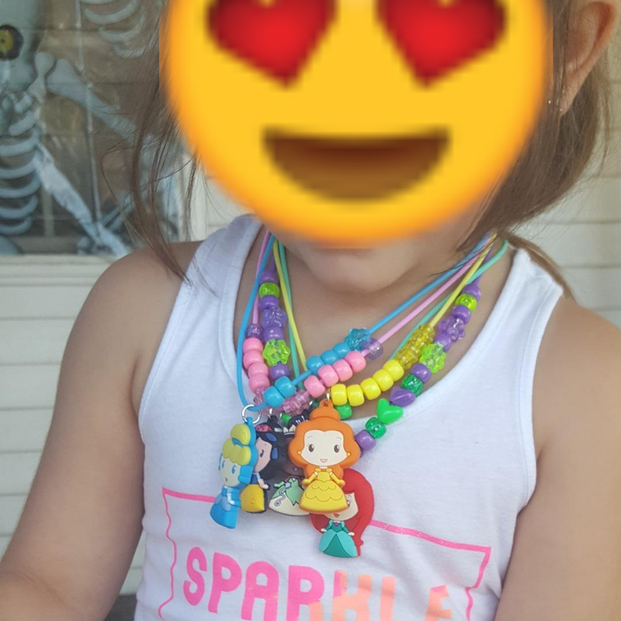 A photo shared by a reviewer showing their child proudly wearing the necklaces they crafted.