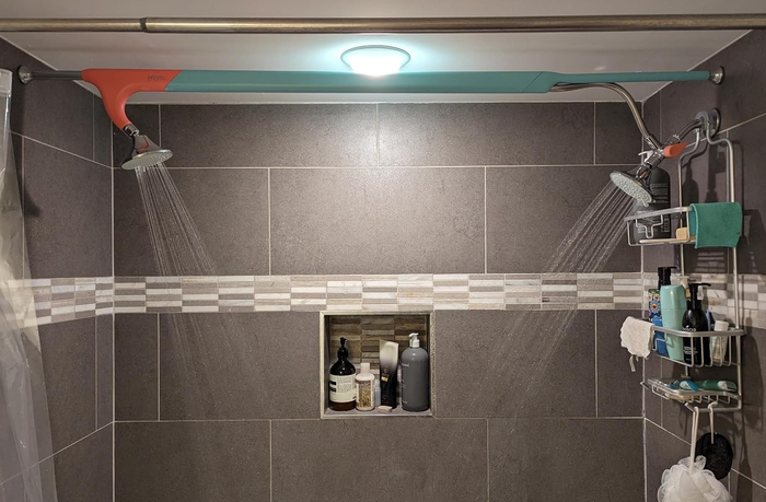 A reviewer photo showing the dual showerheads installed, adding extra comfort to the shower experience.