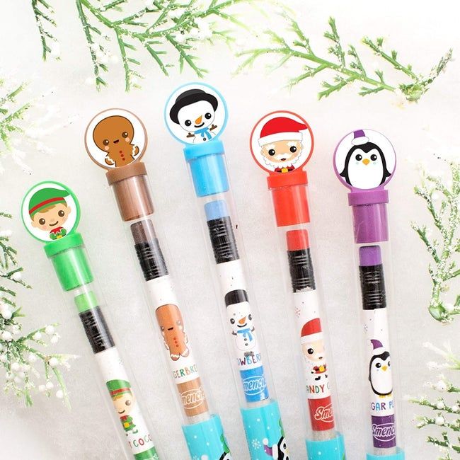 A set of five pencils adorned with charming designs of an elf, a gingerbread man, a snowman, Santa, and a penguin.