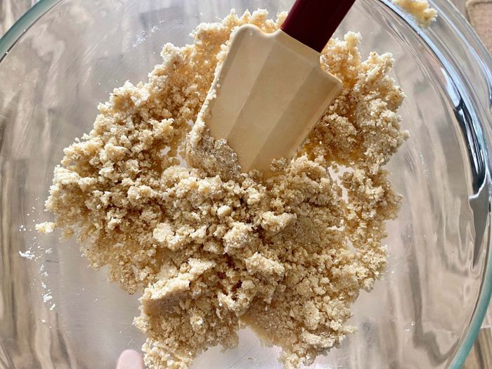 A mixing bowl filled with ingredients for the almond-oat crust.