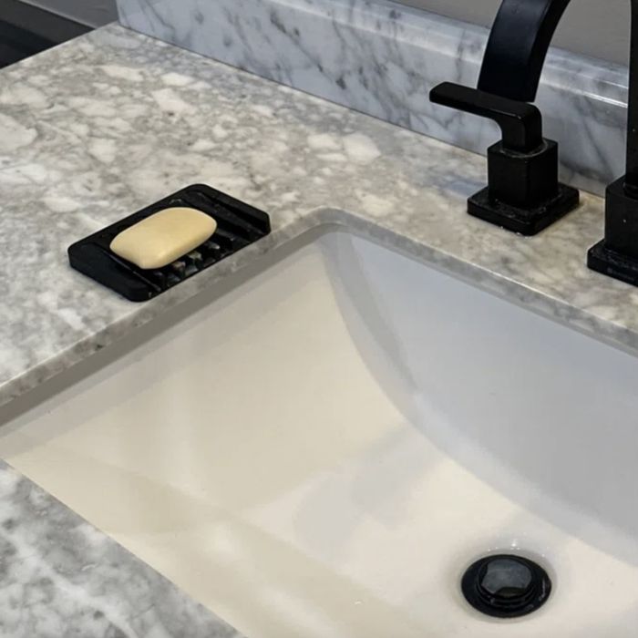 A reviewer’s black silicone soap tray