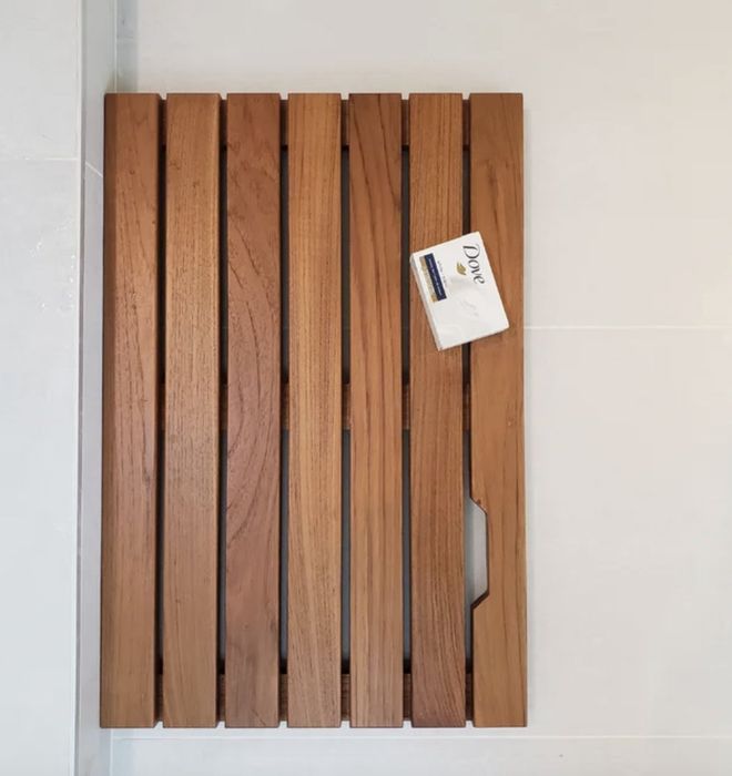 A reviewer’s teak and wood reversible shower mat