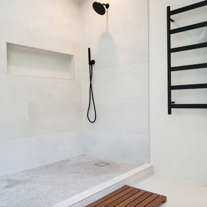 A reviewer’s teak and wood reversible shower mat