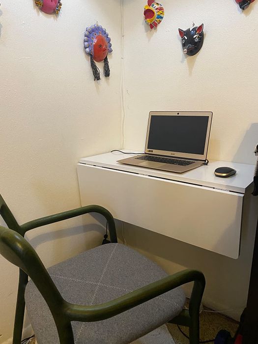 The same desk, with the drop-leaf portion folded down, showing a more compact form.