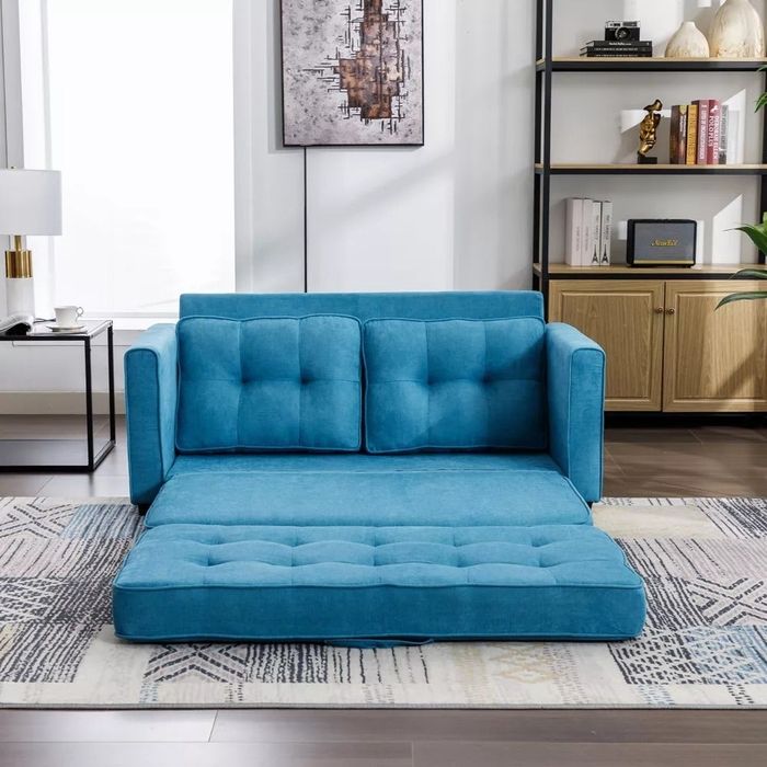 A compact loveseat that can be easily converted into a bed for added functionality.