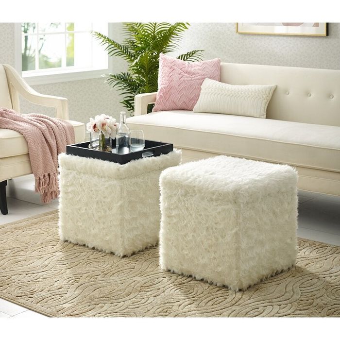 A pair of storage ottomans, one with the lid flipped over to serve as a tray.