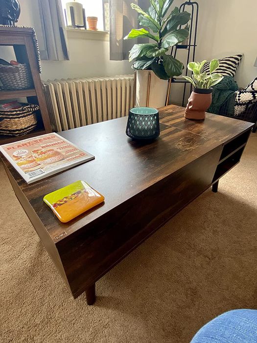 A photo of the coffee table with the top lowered into its original position.
