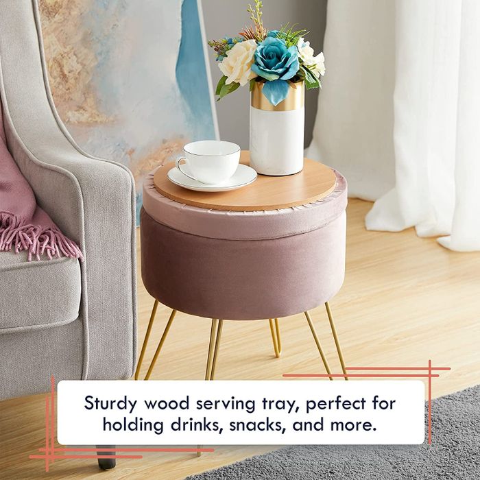 The ottoman with its lid flipped over to reveal the wooden surface on top, transforming it into a functional end table
