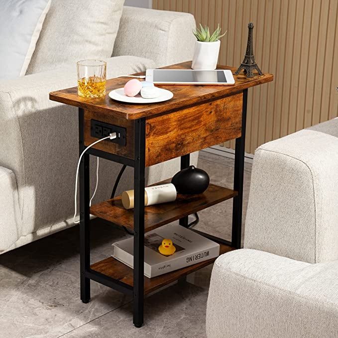 A berry brown table placed between two sofas, with a phone plugged into one of the USB charging ports.