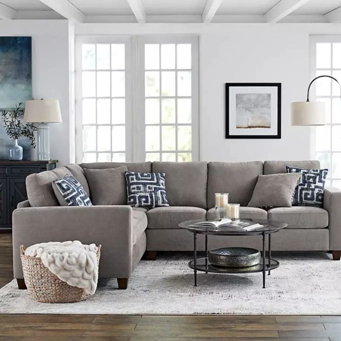 A sectional in pewter, elegantly arranged in a stylish living room.