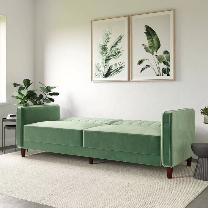 pin-tufted futon transformed into a bed