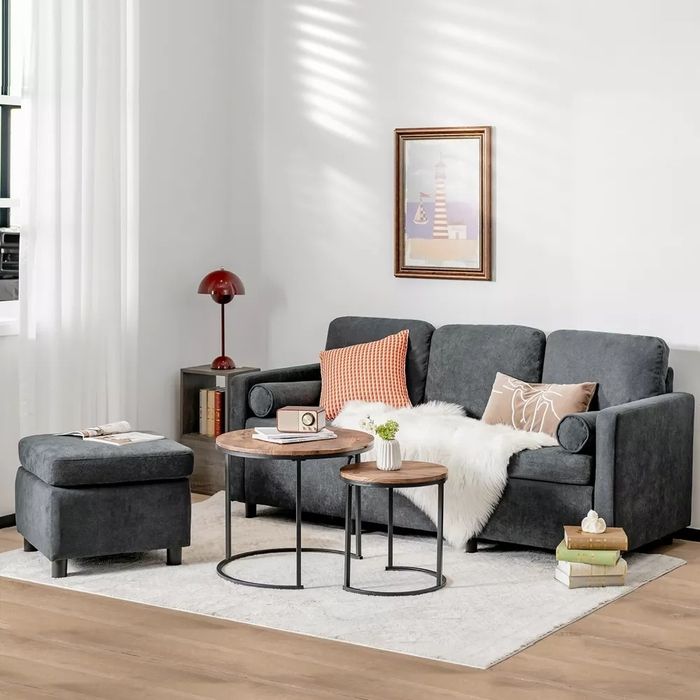 The sectional sofa displayed in a living room, with the ottoman positioned separately.