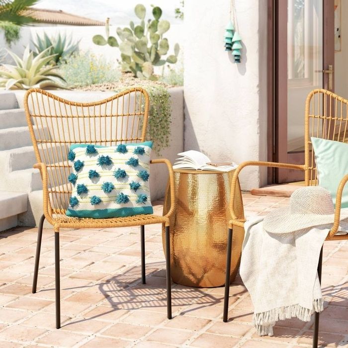 A gold side table is displayed.