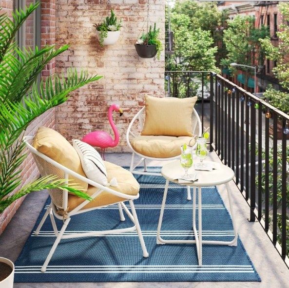 The patio set set up on a balcony.
