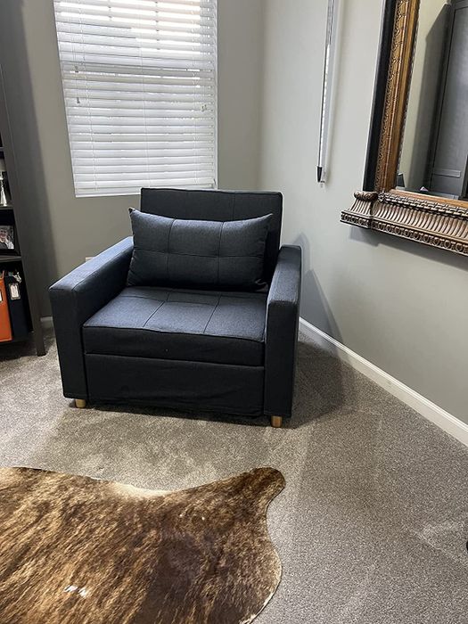 The same navy chair in its compact love seat form as shown by the reviewer.
