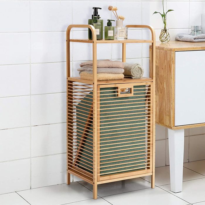 A bamboo storage shelf positioned next to a bathroom sink.