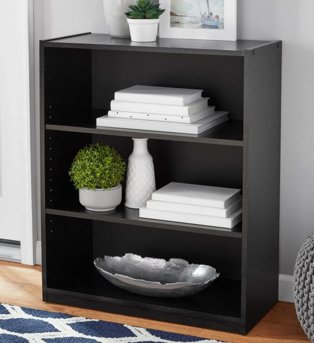 A set of four-tiered black oak shelves, designed for optimal storage and style.