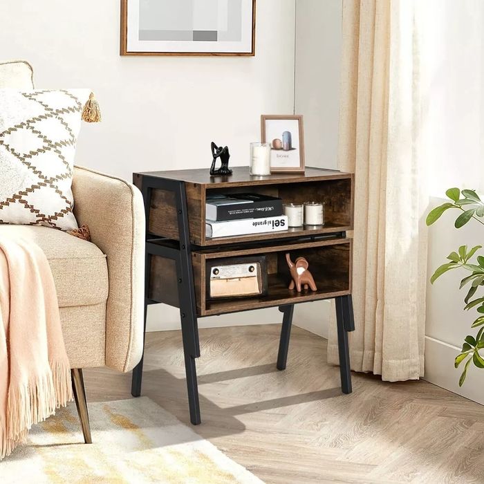 A brown, two-piece stackable nightstand positioned beside an armchair.