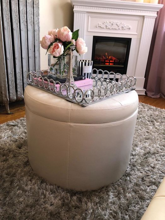 The soft blush-colored ottoman.