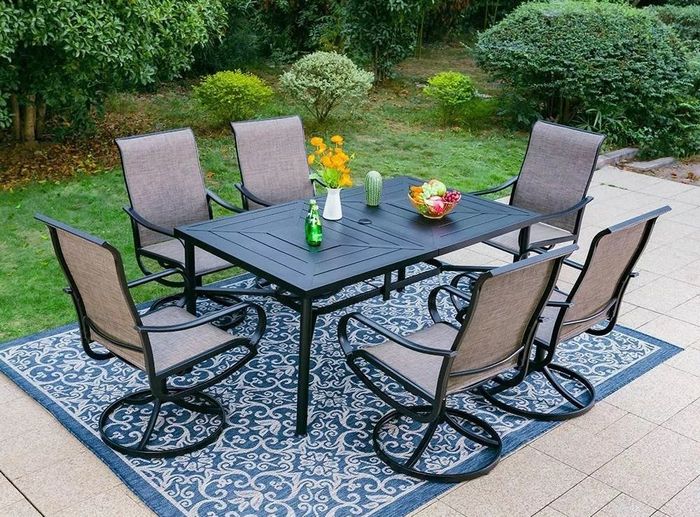 The outdoor dining set arranged on a patio in a charming backyard.