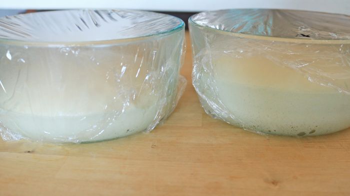 Unbaked bread dough placed in two separate bowls.