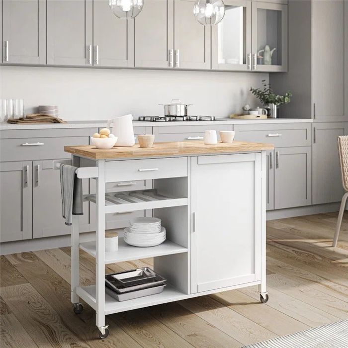 A rolling white kitchen cart with a solid wood top, combining functionality with style.