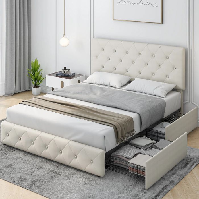 The off-white, tufted platform bed, complete with two spacious storage drawers underneath, is now open for viewing.