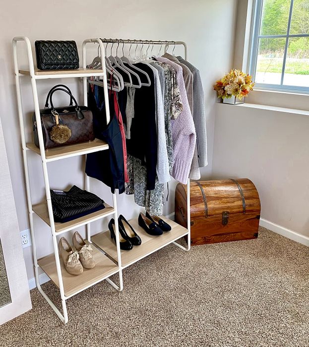 A reviewer's white garment rack featuring four shelves.