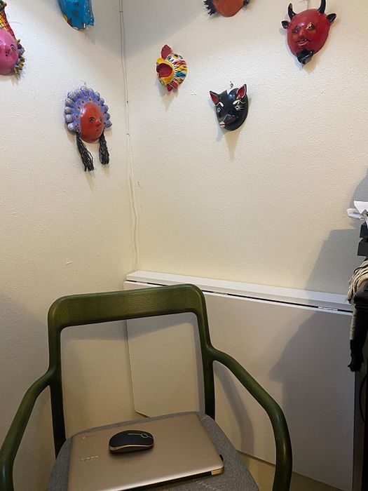 The desk is entirely folded down, with a chair positioned in front of it for use.