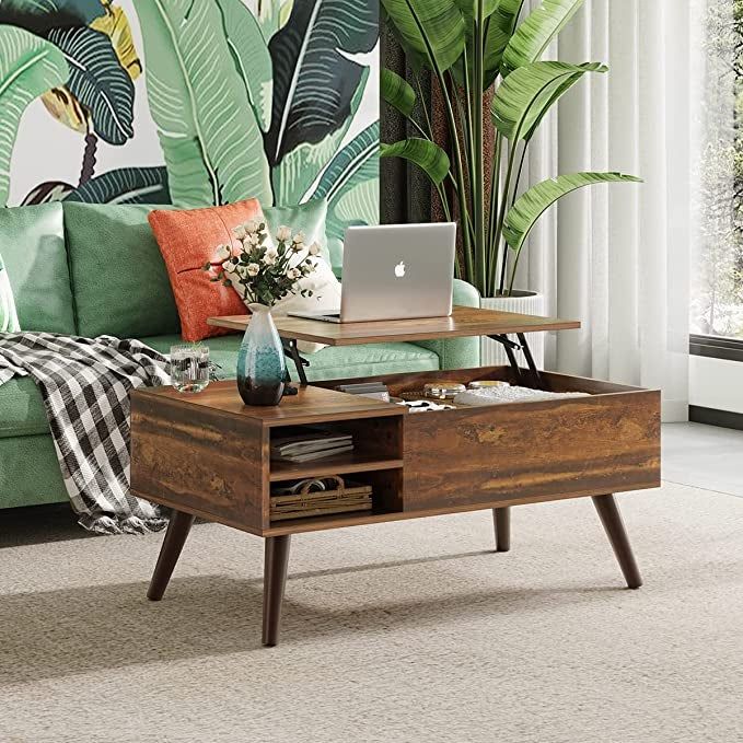 A photo of the coffee table with the top lifted, showing a laptop placed on it.