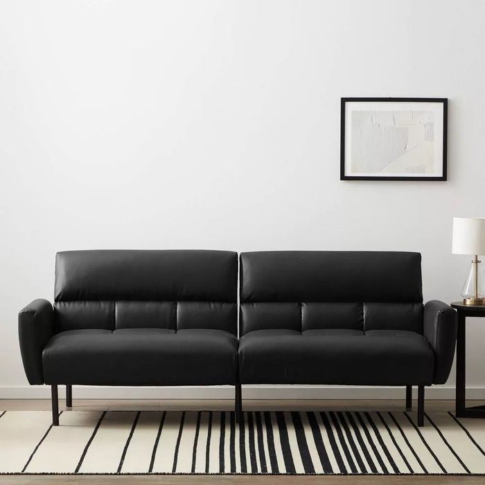 The stylish black tufted sofa bed, designed for both comfort and elegance.